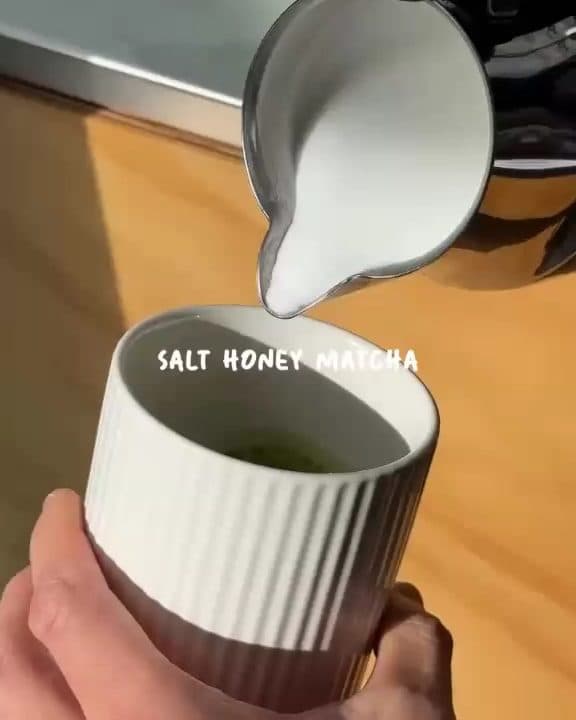 Milk foam poured into a salt honey matcha